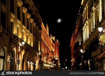 Illuminated street in Paris France with bright moon