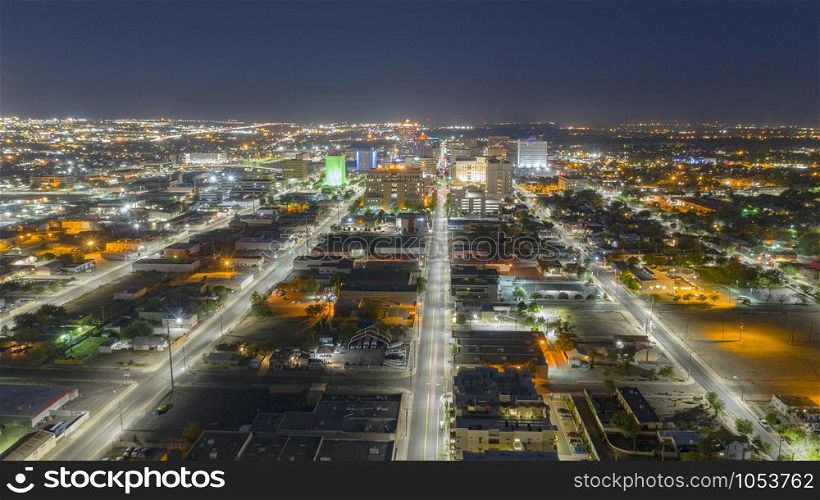 Illuminated streets lead travelers into Albuquerque New Mexico before sunrise