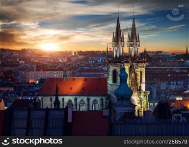 Illuminated Tynsky temple in Prague at sunset