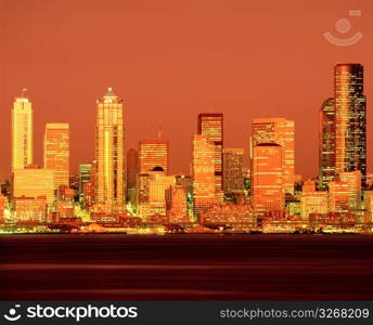 Illuminated urban highrises on city waterfront