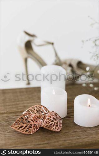illuminated white candles wooden table