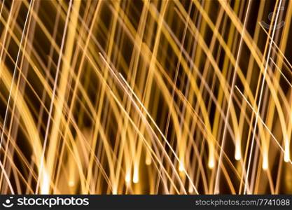 illumination and backgrounds concept - golden electric light effect lines on dark background. golden electric light effect on dark background