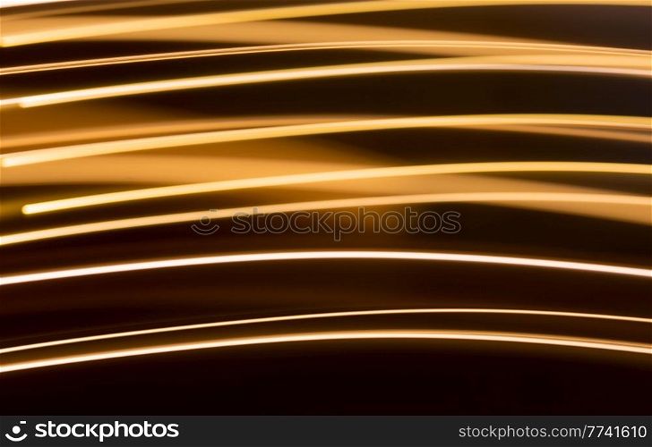 illumination and backgrounds concept - golden electric light effect lines on dark background. golden electric light effect on dark background