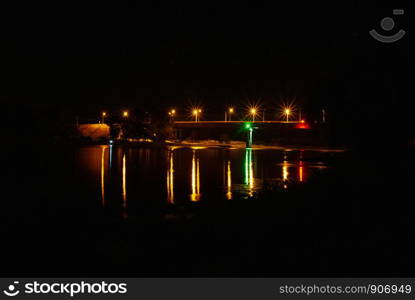 Illumination on the bridge at night. Long exposure illuminated bridge night shot. Multi-colored night illumination on the bridge. Night landscape