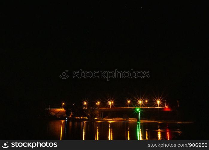 Illumination on the bridge at night. Long exposure illuminated bridge night shot. Multi-colored night illumination on the bridge. Night landscape