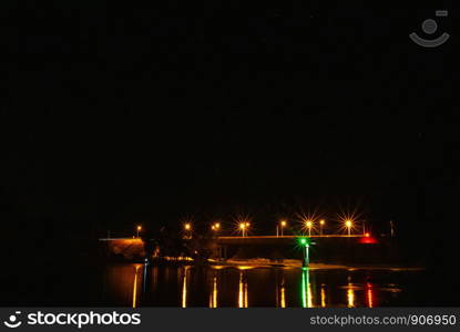 Illumination on the bridge at night. Long exposure illuminated bridge night shot. Multi-colored night illumination on the bridge. Night landscape