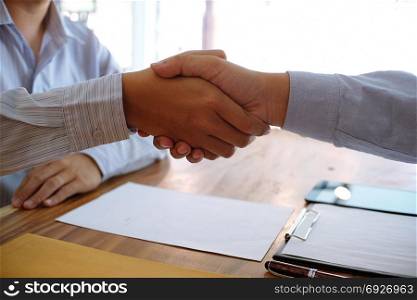 Image business mans handshake after signing contract making a deal. Business partnership meeting concept