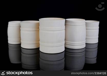 Image collection of wooden jars for the kitchen on black background