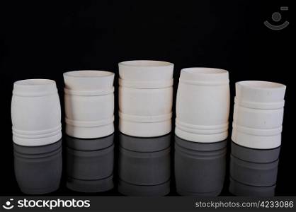 Image collection of wooden jars for the kitchen on black background