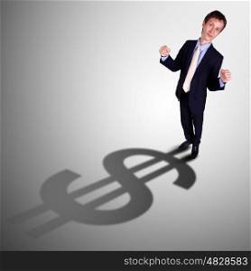 Image of a business man with a shadow shaped as a currency sign