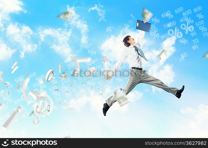 Image of a businessman jumping high against blue sky background