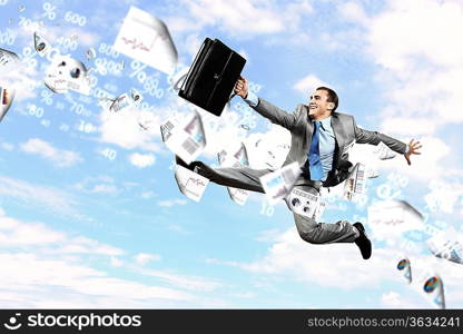 Image of a businessman jumping high against blue sky background