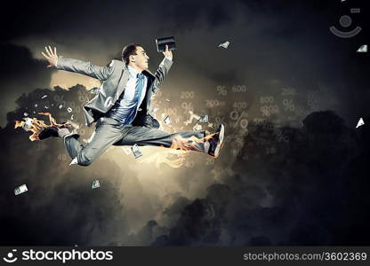 Image of a businessman jumping high against financial background