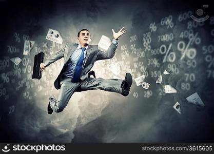 Image of a businessman jumping high against financial background