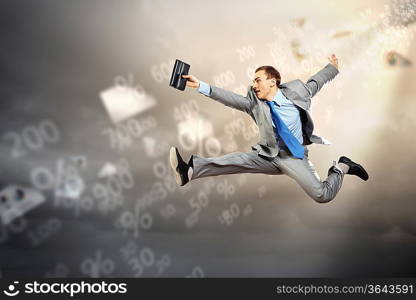 Image of a businessman jumping high against financial background