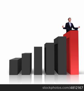 Image of a businessman standing on the top of financial charts