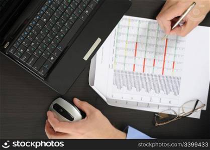 Image of a businessman working with documents in the office of the table
