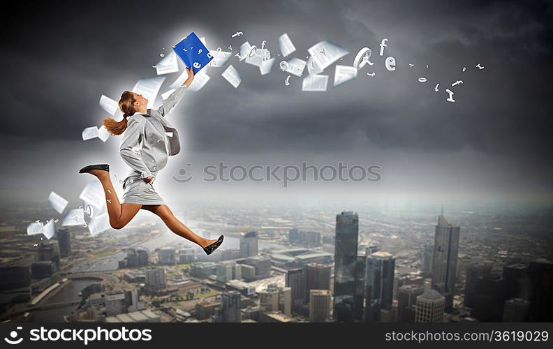 Image of a businesswoman jumping high against financial background