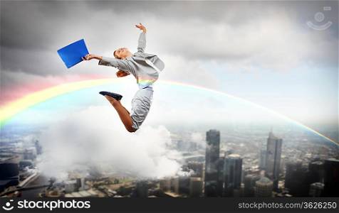 Image of a businesswoman jumping high against financial background