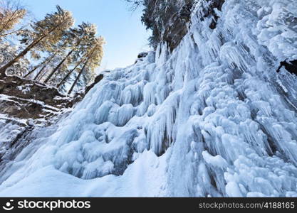 Image of a frozen waterfall in deep rock canyon in Carpathian mountains near Manyava village