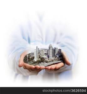 Image of a modern cityscape in the hand of a businessman
