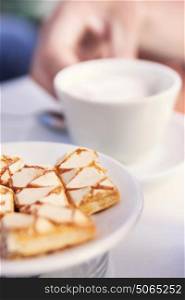 Image of a piece of homemade cake, cup of tea