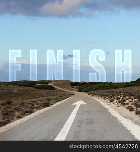 Image of a road with white arrow and finish sign