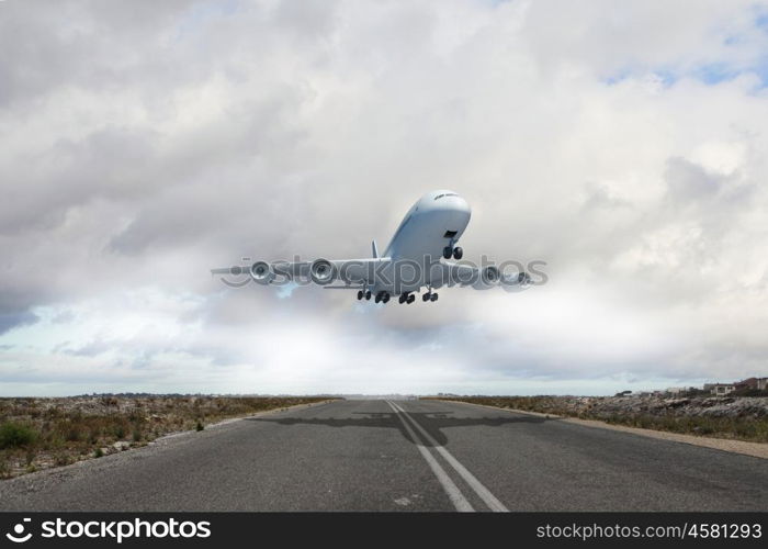 Image of a white flying passenger plane