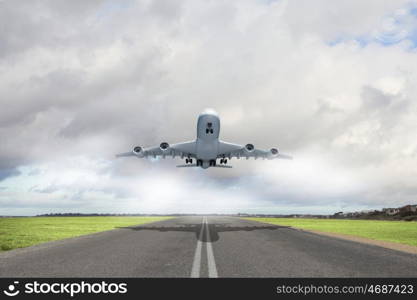 Image of a white flying passenger plane