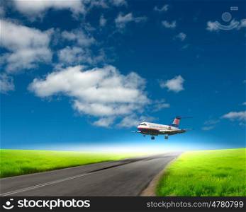Image of a white passenger plane and blue sky with clouds