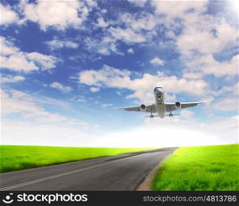 Image of a white passenger plane and blue sky with clouds