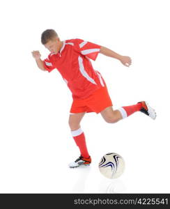 Image of a young football player with the ball in the red uniform. Isolated on white background