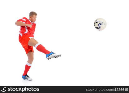 Image of a young football player with the ball in the red uniform. Isolated on white background