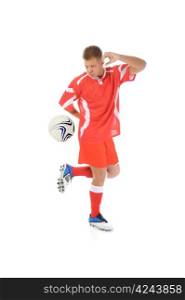 Image of a young football player with the ball in the red uniform. Isolated on white background