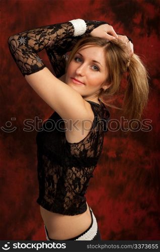 Image of a young girl touching her hair and posing for photo
