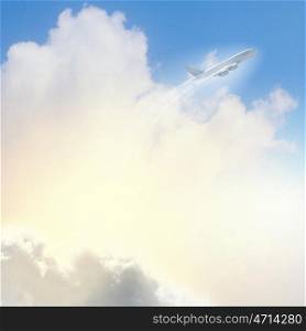 Image of airplane in sky. Image of flying airplane in clear sky with sun at background