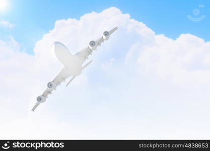 Image of airplane in sky. Image of flying airplane in sky with clouds at background