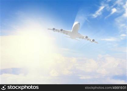 Image of airplane in sky. Image of flying airplane in sky with clouds at background
