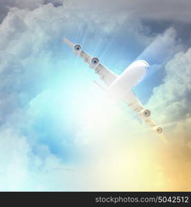 Image of airplane in sky. Image of flying airplane in sky with clouds at background