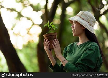 Image of an Asian woman In the concept of planting trees for the environment