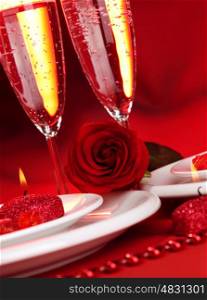 Image of beautiful Valentine day dinner still life, two glasses for champagne, alcohol beverage, romantic drink, sparkling wine, red rose and candle, festive table setting, love concept&#xA;
