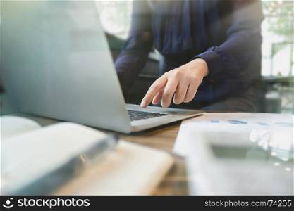 image of bookkeeper / financial inspector calculating on investment data with documents and laptop