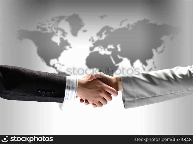 image of business handshake. business handshake against black background with map image