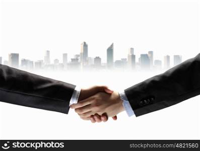 image of business handshake. business handshake against white background with city image
