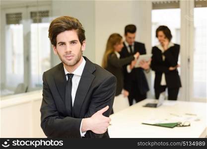 Image of business leader looking at camera in working environment