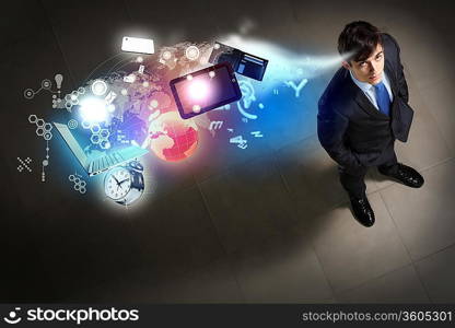 Image of business objects flying in air top view against businessman background
