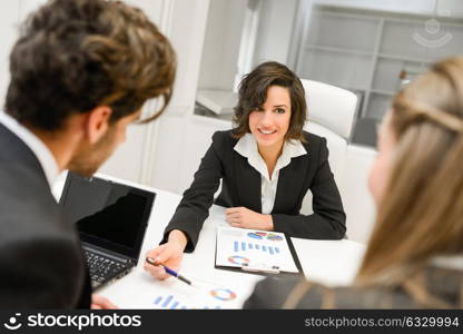 Image of business partners discussing documents and ideas at meeting