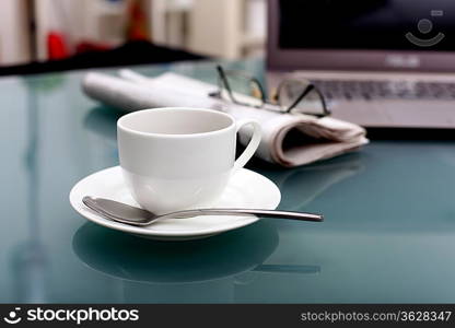 Image of business table with a cup of coffee and norebook