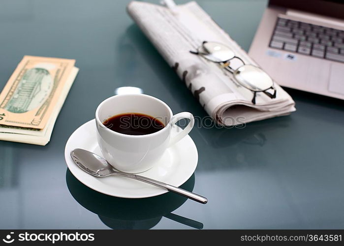 Image of business table with a cup of coffee and norebook