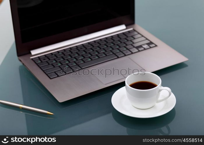 Image of business table with a cup of coffee and norebook